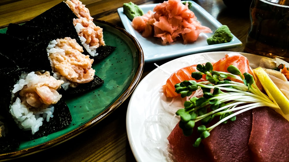 Crab hand roll and a plate of tuna and salmon sashimi